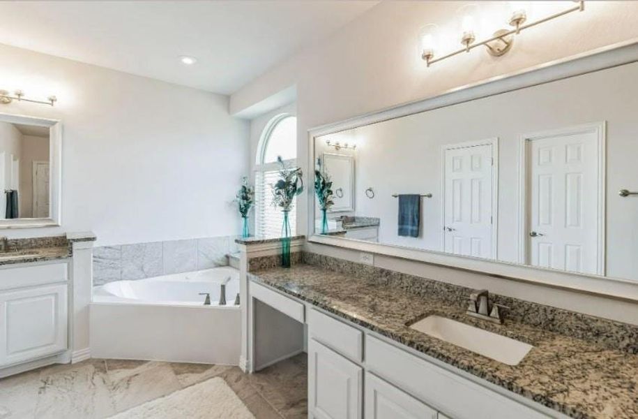 Bathroom with vanity, a tub, and tile patterned floors