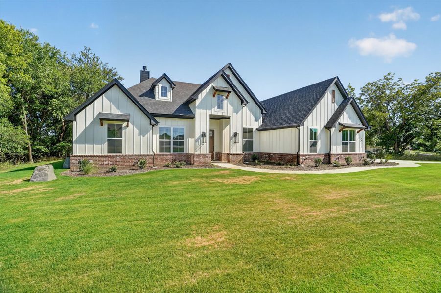 Front exterior of a new home in Cartwright Ranch, Weatherford, TX, highlighting curb appeal (Image 2). Front exterior of a new home in Cartwright Ranch, Weatherford, TX, highlighting curb appeal (Image 2).