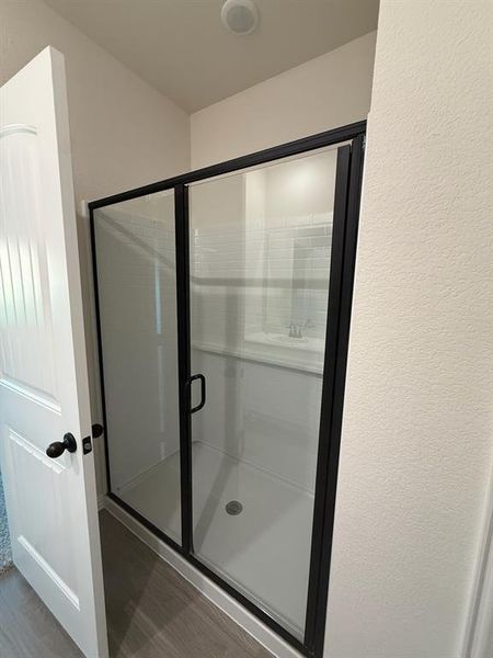 Bathroom with wood finished floors and a shower stall Bathroom with wood finished floors and a shower stall
