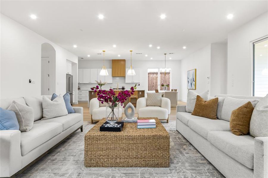 Living room with sink and light hardwood / wood-style flooring