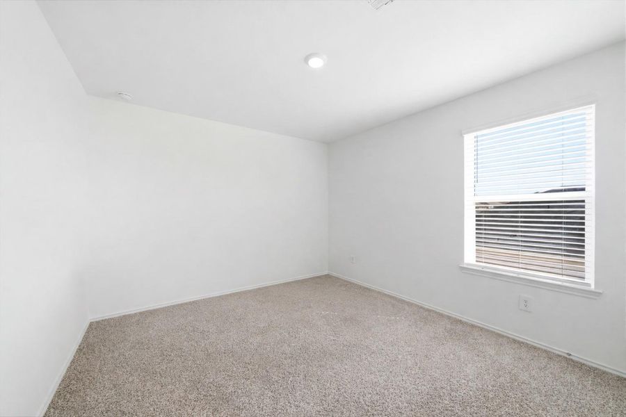 Well-lit 3rd upstairs secondary bedroom with a spacious closet and a welcoming, adaptable layout for study, sleep, or play.