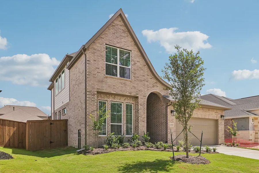 Front exterior of a new home in Parkside on the River, Georgetown, TX, highlighting curb appeal (Image 19).