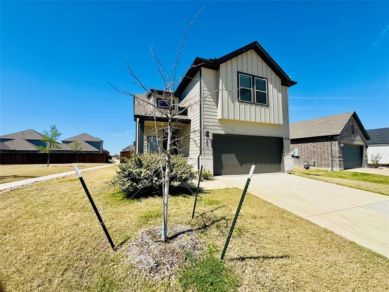 Front exterior of a new home in Trails of Lavon, Lavon, TX, highlighting curb appeal (Image 17).