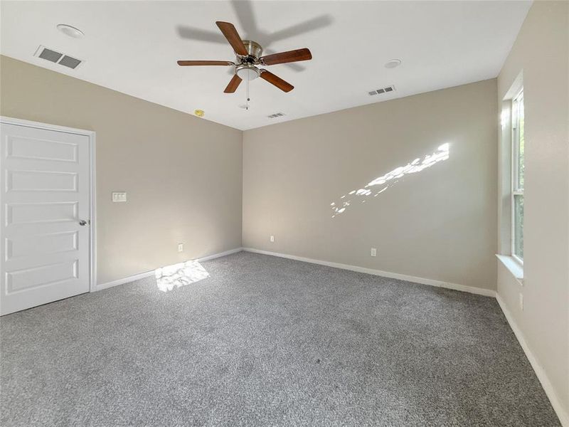 Spare room with carpet floors and ceiling fan
