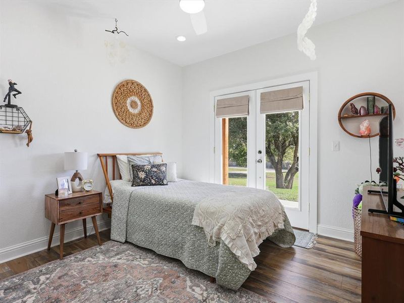 Bedroom featuring access to outside, wood finished floors, french doors, ceiling fan, and recessed lighting