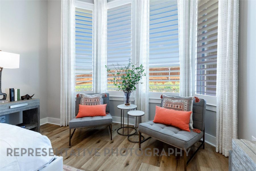 Living area featuring wood finished floors and baseboards Living area featuring wood finished floors and baseboards