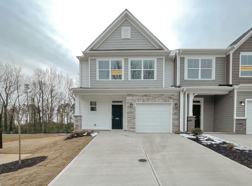 Front exterior of a new home in East Main Townes, Spartanburg, SC, highlighting curb appeal (Image 1). Front exterior of a new home in East Main Townes, Spartanburg, SC, highlighting curb appeal (Image 1).