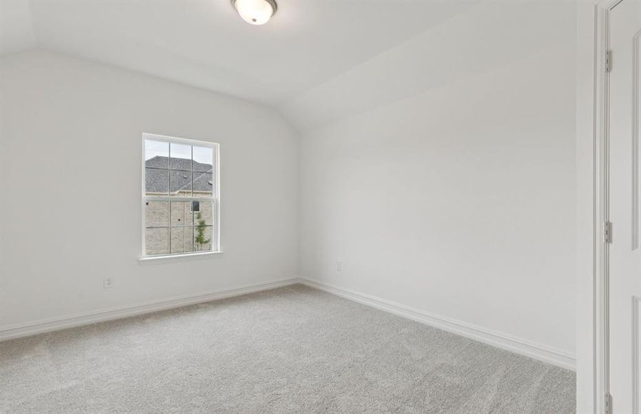 Roomy secondary bedroom with extensive closet storage  *Real home pictured