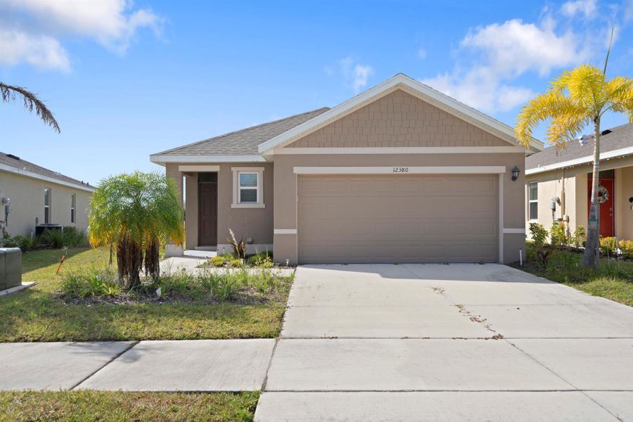 Front exterior of a new home in Central Park 40s, Port St. Lucie, FL, highlighting curb appeal (Image 18).