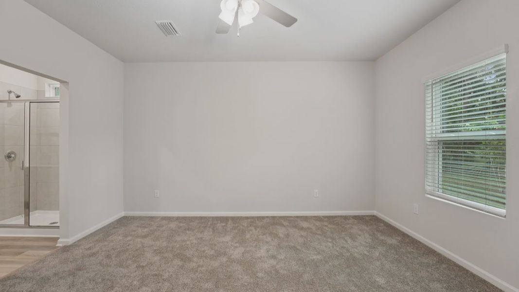 Indulge in tranquility with plush carpeting and abundant light in Palm Coast. Spa-like shower enhances comfort.
