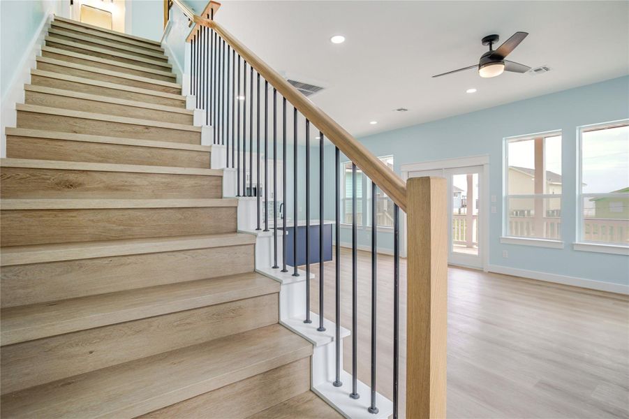 Rod iron meets wood! Beautiful staircase that is engineered to be functional yet a designer look to the home!