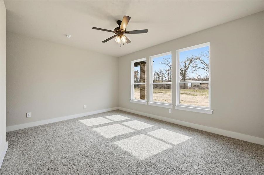 Spare room with carpet flooring and ceiling fan
