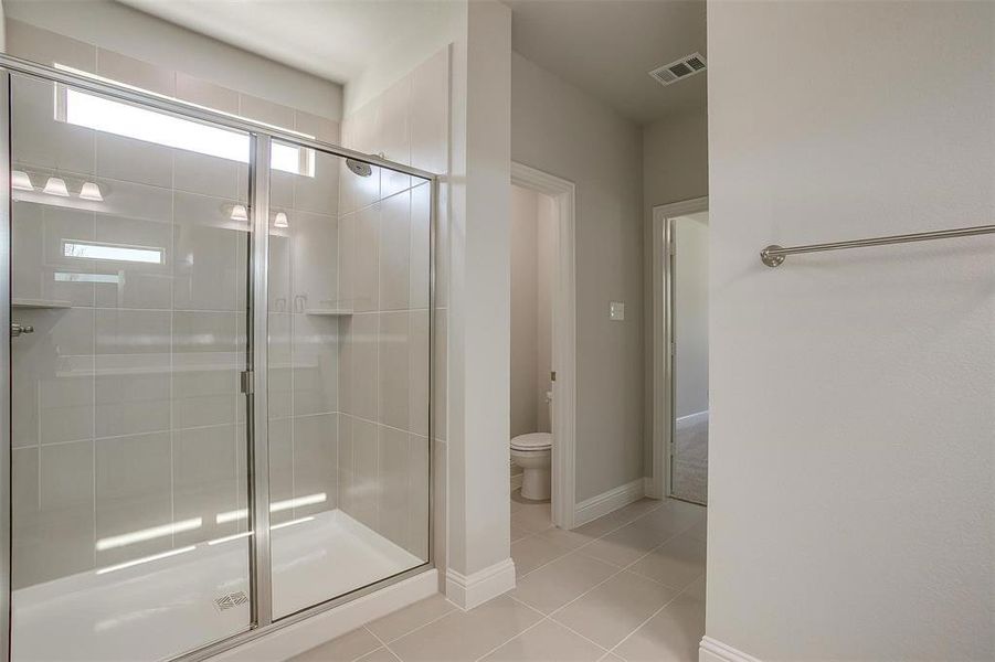 Full bathroom featuring a stall shower and tile patterned flooring Full bathroom featuring a stall shower and tile patterned flooring