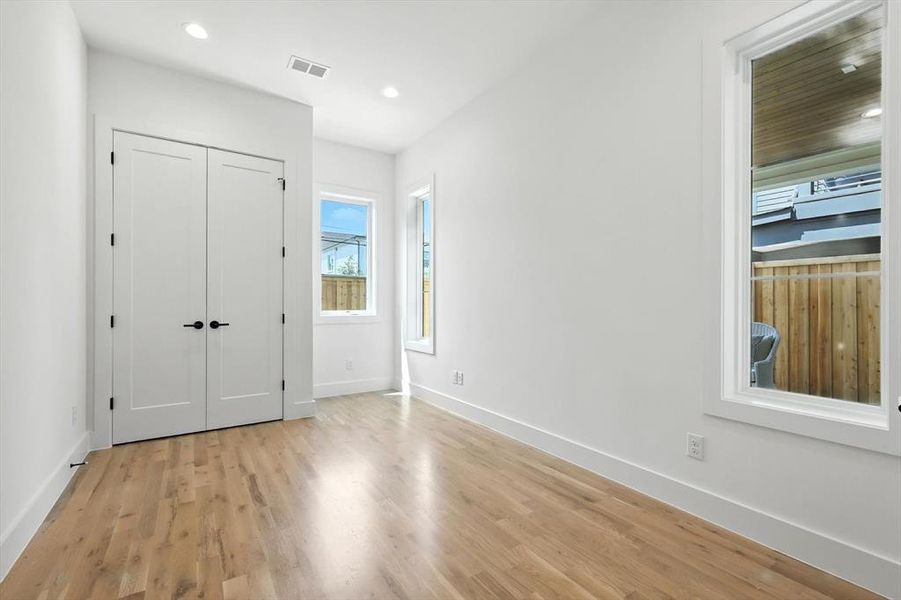Unfurnished bedroom featuring light wood finished floors, recessed lighting, and a closet Unfurnished bedroom featuring light wood finished floors, recessed lighting, and a closet
