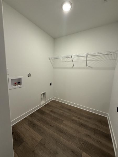 Laundry room featuring dark wood-style floors, electric dryer hookup, and washer hookup