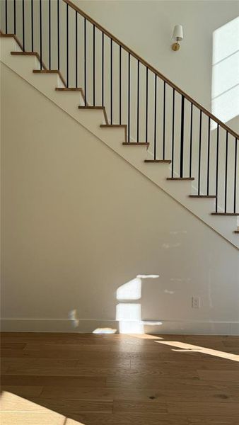 Staircase featuring hardwood / wood-style flooring