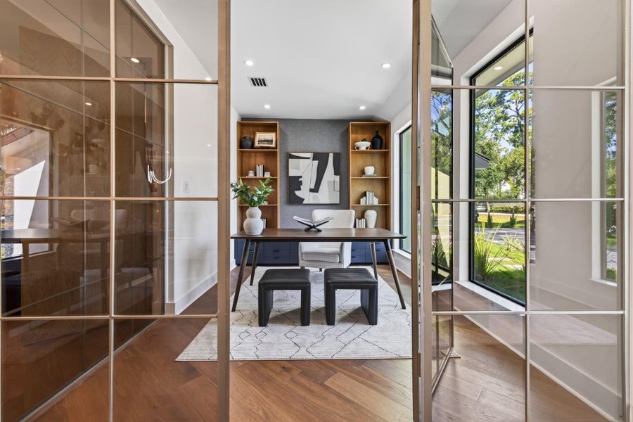 Custom glass-enclosed office creates a striking architectural feature adjacent to the entertaining spaces.