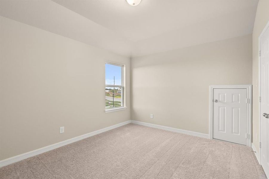 Your secondary bedroom features plush carpet, fresh paint, closet, and a large window that lets in plenty of natural lighting.