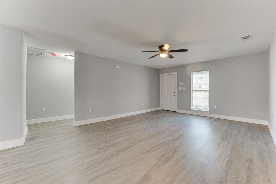 Spare room featuring ceiling fan and light wood-type flooring