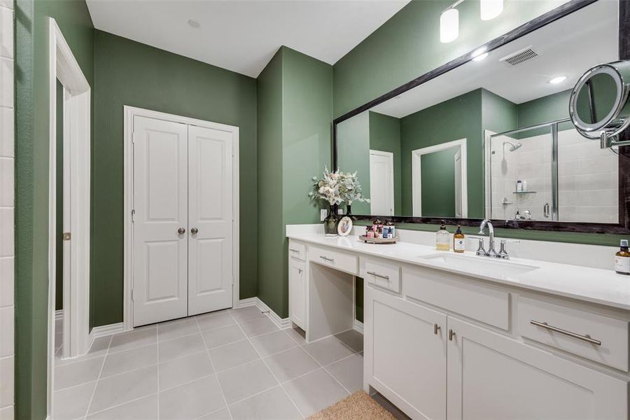 Bathroom with a shower stall, vanity, a closet, and light tile patterned floors