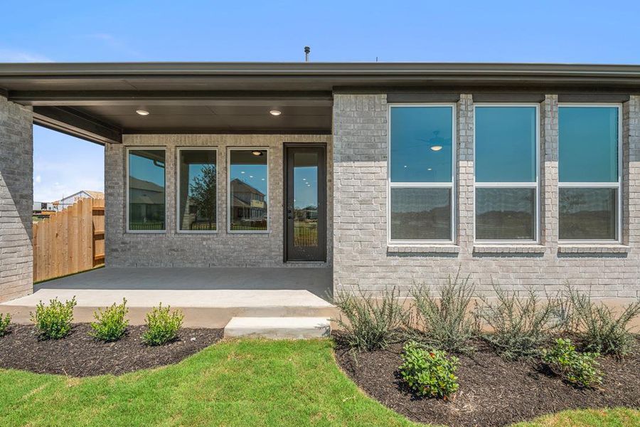 Front exterior of a new home in Flora, Hutto, TX, highlighting curb appeal (Image 21).