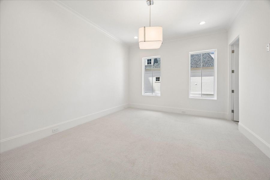 The first of the second-floor bedrooms features high-performance carpet, en-suite bathroom, and spacious walk-in closet.