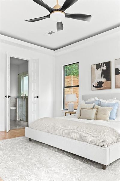 Bedroom with ceiling fan, ensuite bathroom, and wood-type flooring