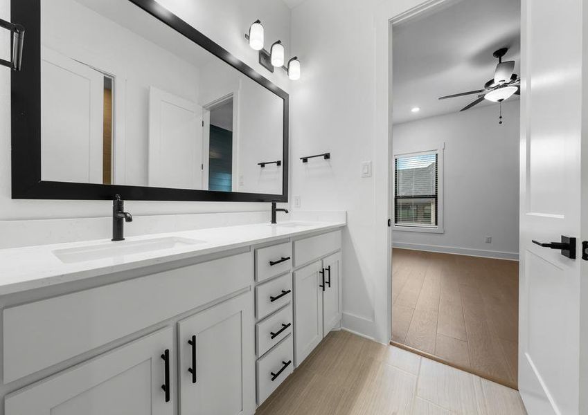 The secondary bathroom has a large, dual-sink vanity with plenty of cabinet space.