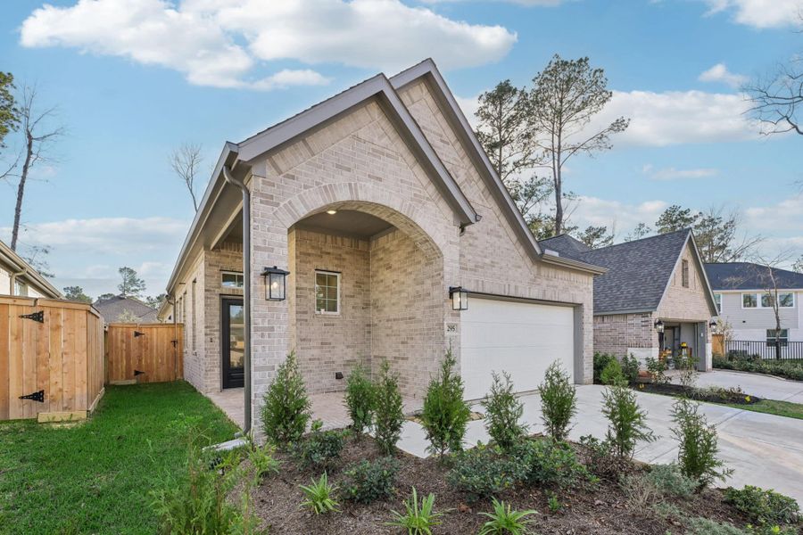 Front exterior of a new home in The Woodlands Hills, Willis, TX, highlighting curb appeal (Image 28).