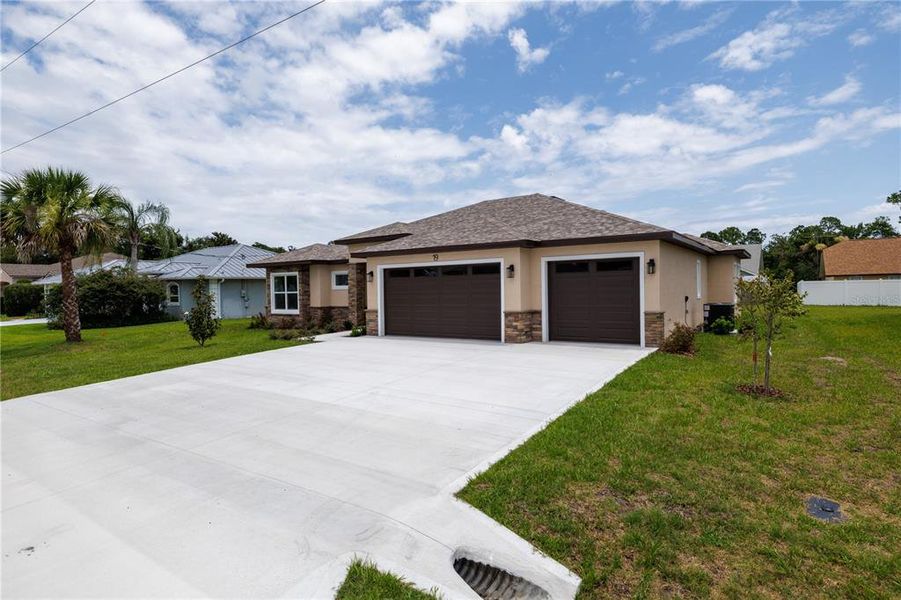 Front exterior of a new home in , Palm Coast, FL, highlighting curb appeal (Image 2). Front exterior of a new home in , Palm Coast, FL, highlighting curb appeal (Image 2).