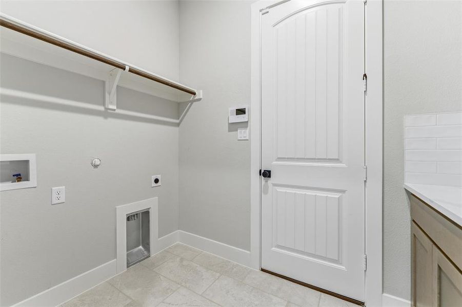 Laundry room featuring gas dryer hookup, hookup for an electric dryer, and washer hookup