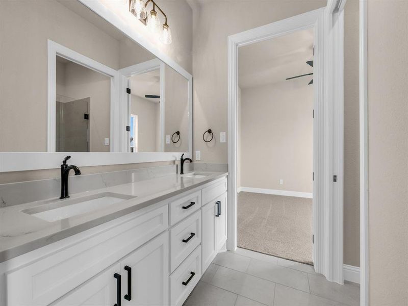 Bathroom featuring tile patterned flooring, ceiling fan, walk in shower, and vanity