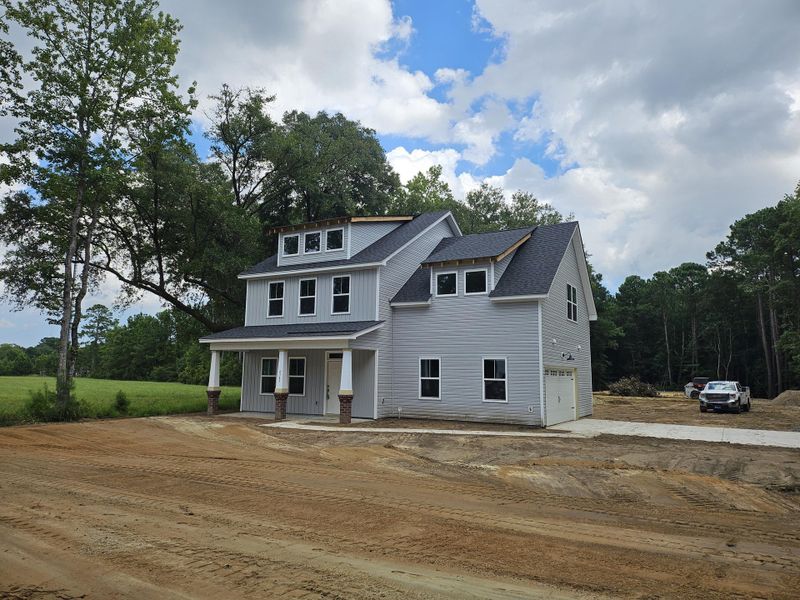 Front exterior of a new home in , Awendaw, SC, highlighting curb appeal (Image 1). Front exterior of a new home in , Awendaw, SC, highlighting curb appeal (Image 1).