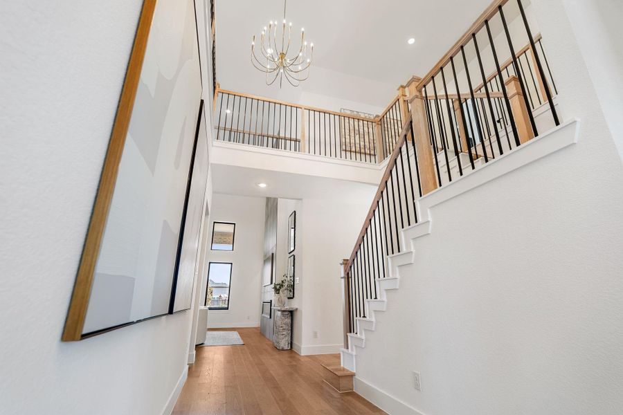 The elegant staircase features warm wood treads paired with sleek iron balusters, creating a striking architectural statement. The elegant staircase features warm wood treads paired with sleek iron balusters, creating a striking architectural statement.