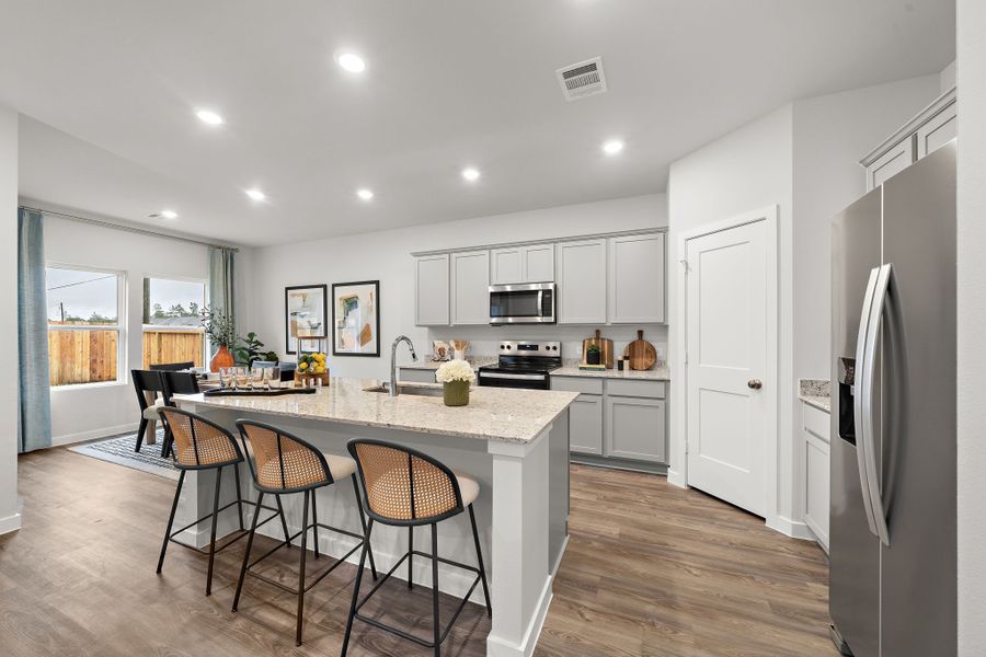 A kitchen with a dining table and chairs. A kitchen with a dining table and chairs.