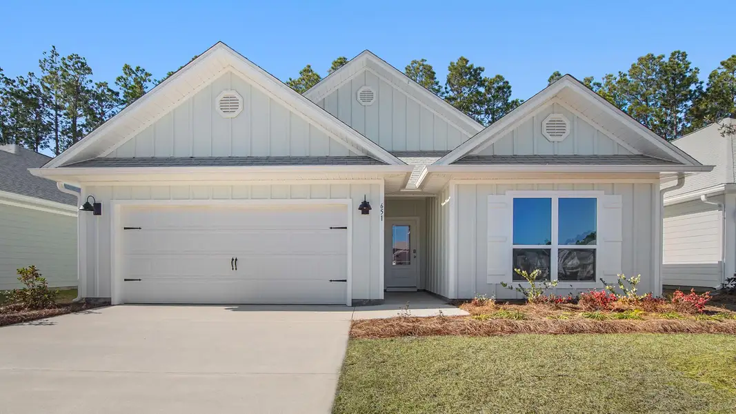 Front exterior of a new home in Bayside at Ward Creek, Panama City Beach, FL, highlighting curb appeal (Image 1).