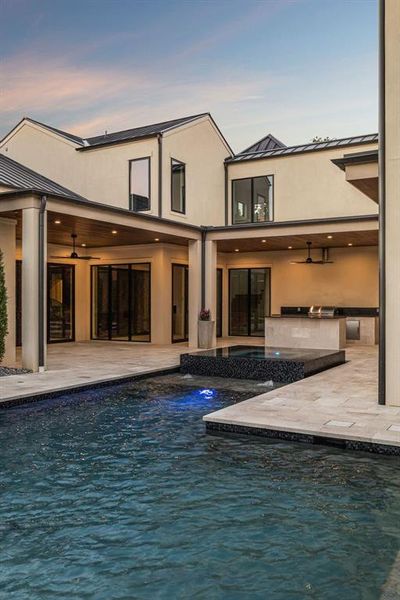 Swimming pool with ceiling fan, a patio, and exterior kitchen Swimming pool with ceiling fan, a patio, and exterior kitchen