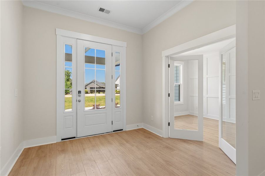 Natural light streams through the elegant French d