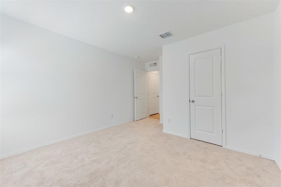 Unfurnished bedroom featuring light carpet