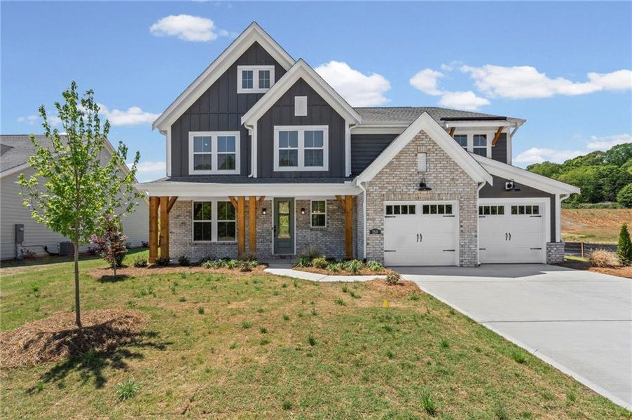 Front exterior of a new home in Hidden Fields, Hoschton, GA, highlighting curb appeal (Image 2). Front exterior of a new home in Hidden Fields, Hoschton, GA, highlighting curb appeal (Image 2).