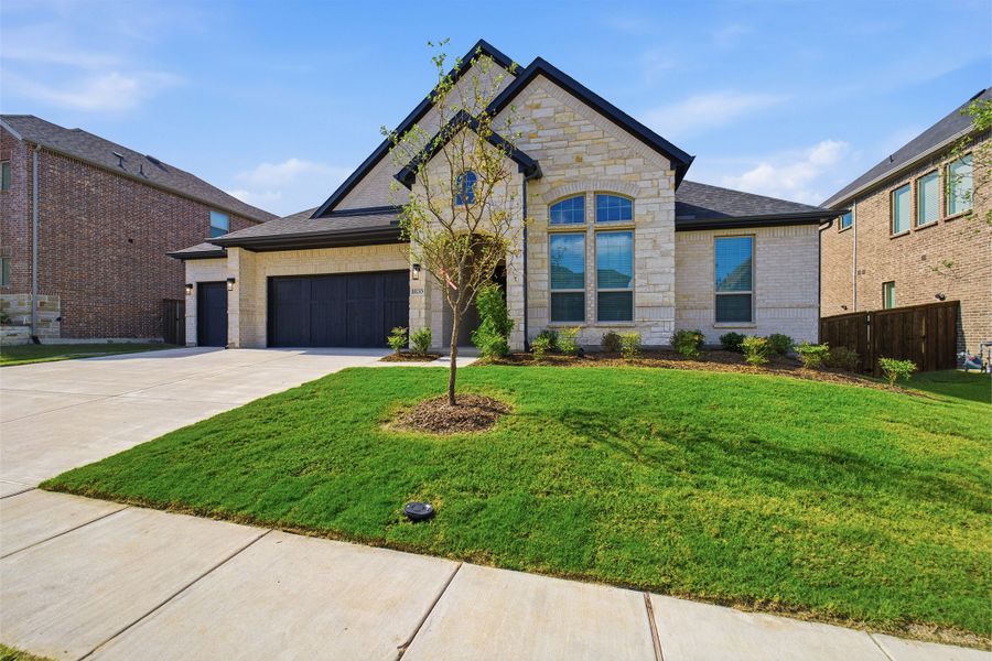 Front exterior of a new home in Sonoma Verde, Heath, TX, highlighting curb appeal (Image 2). Front exterior of a new home in Sonoma Verde, Heath, TX, highlighting curb appeal (Image 2).