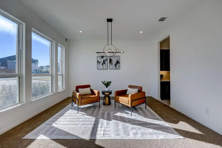 Sitting room featuring carpet, recessed lighting, and a chandelier