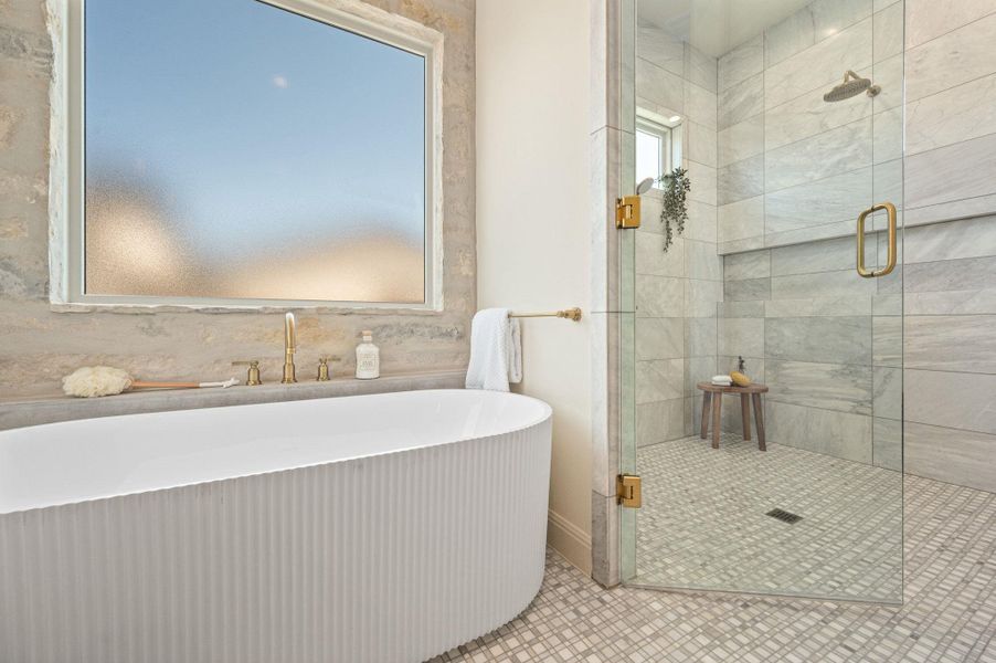 Bathroom with a stall shower and a freestanding tub