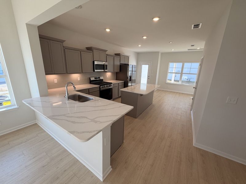 Peninsula style kitchen with an overhang for extra stools