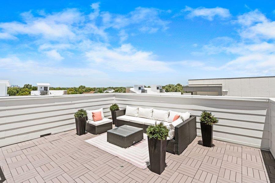 Unwind outdoors on this expansive rooftop terrace, offering tranquil views and private relaxation. Unwind outdoors on this expansive rooftop terrace, offering tranquil views and private relaxation.