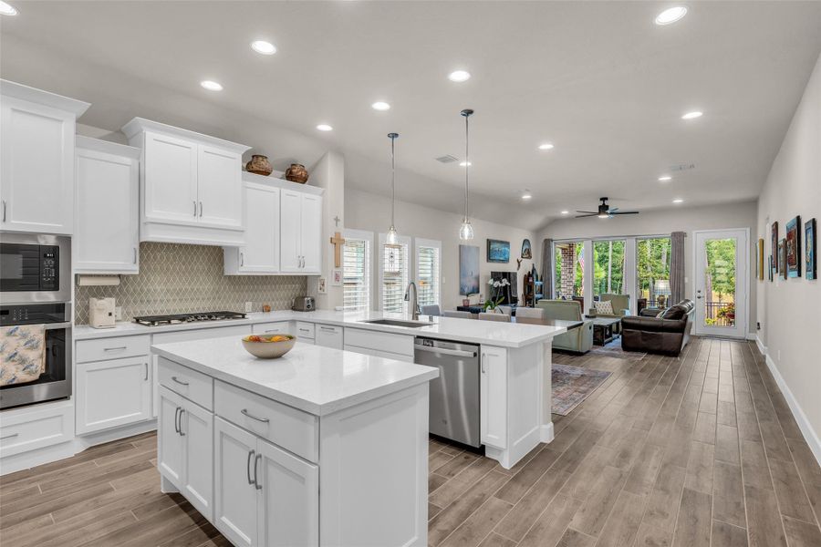 The open concept design flows seemlessly from kitchen to living area. The open concept design flows seemlessly from kitchen to living area.