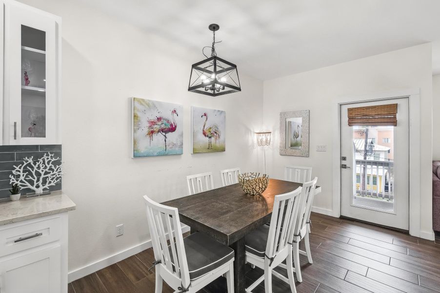 Dining space with dark wood-style floors and baseboards Dining space with dark wood-style floors and baseboards