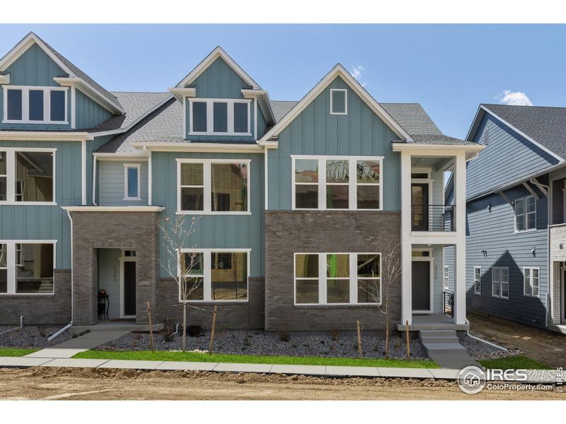 Front exterior of a new home in Kinston Mainstreet Townhomes, Loveland, CO, highlighting curb appeal (Image 20).