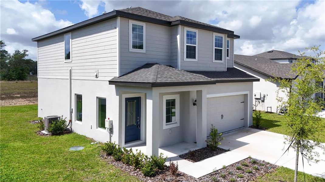 Front exterior of a new home in , Astatula, FL, highlighting curb appeal (Image 2). Front exterior of a new home in , Astatula, FL, highlighting curb appeal (Image 2).