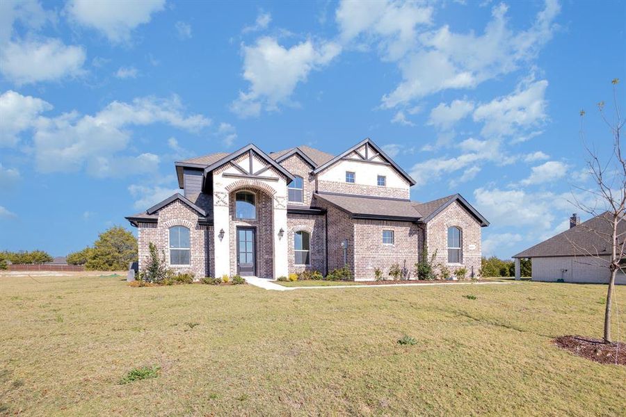 Front exterior of a new home in Sagebrush Addition, Midlothian, TX, highlighting curb appeal (Image 16).